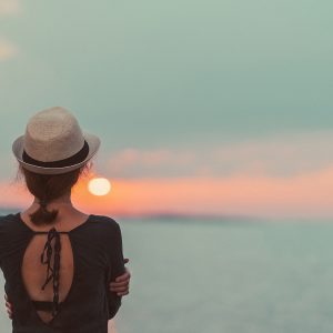 Girl staring at sunset thinking about Convenient Counseling Services