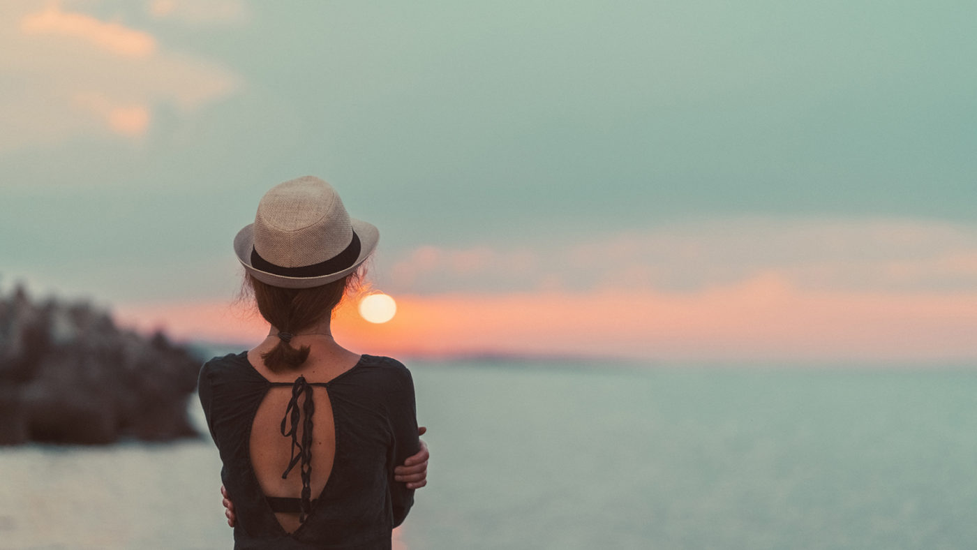 Girl staring at sunset thinking about Convenient Counseling Services