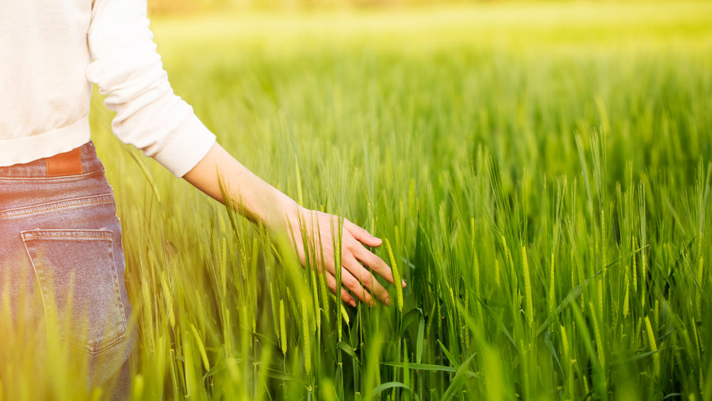 Girl walking in grassy filed in Syracuse, NY