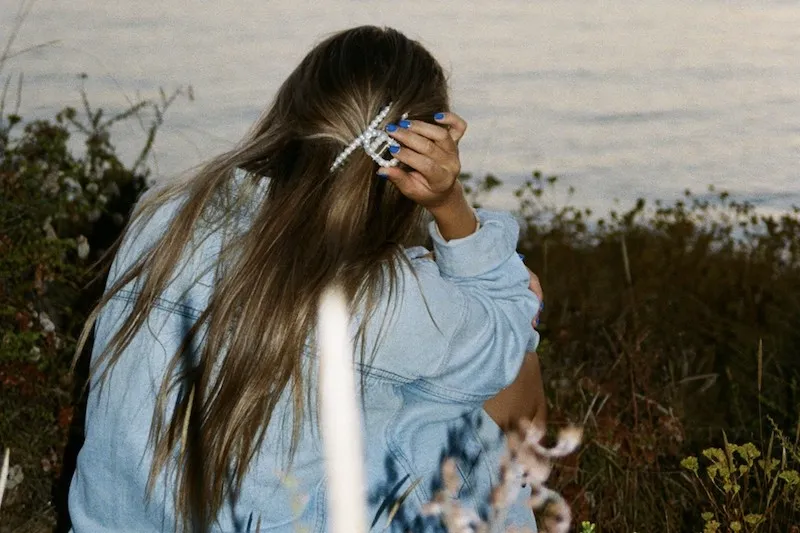 film photograph of woman looking out at lake