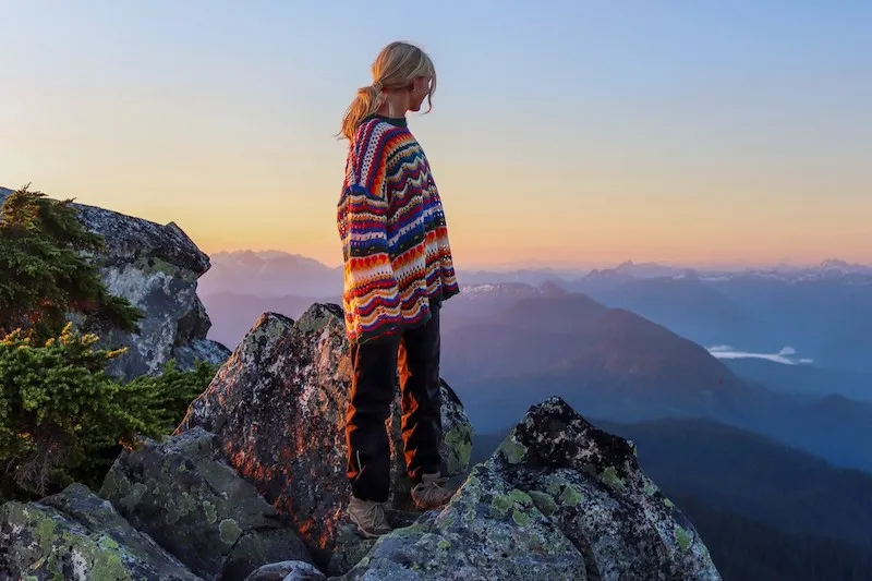woman on mountain top at sunrise