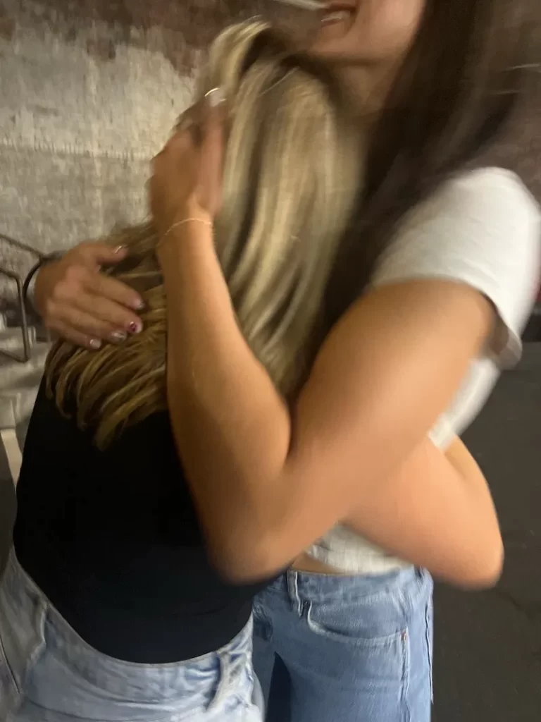 blurry image of women hugging