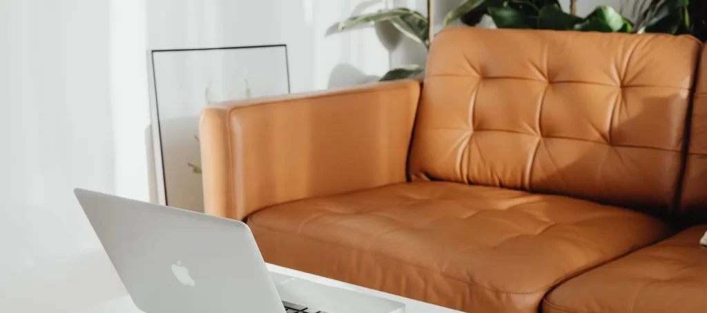 laptop on table by sofa