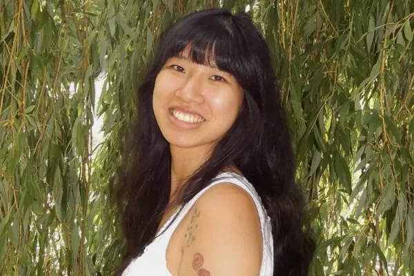 rebecca collins standing in front of weeping willow smiling