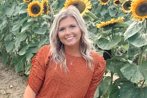 marissa smiling in field of sunflowers